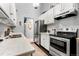 Bright kitchen with white cabinets, stainless steel appliances, and marble countertops offering a clean and modern look at 4070 S Atchison Way # 304, Aurora, CO 80014