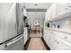 Contemporary kitchen featuring stainless steel appliances, sleek white cabinetry and open to the dining area at 4070 S Atchison Way # 304, Aurora, CO 80014