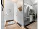 View of the entryway next to a kitchen with stainless steel appliances and coat hooks by the front door at 4070 S Atchison Way # 304, Aurora, CO 80014