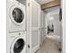 Hallway showing the stacked washer and dryer next to a closet and entrance at 4070 S Atchison Way # 304, Aurora, CO 80014