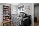 Cozy bedroom with a daybed, built-in bookcase, and ample natural light from the large window at 704 N Pearl St # 0-323, Denver, CO 80203