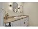 Bathroom featuring double vanity with granite countertops, modern lighting, and white cabinets at 5161 S Emporia Way, Greenwood Village, CO 80111