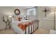 Comfortable bedroom with cozy iron bed, round mirror, and lots of natural light at 5161 S Emporia Way, Greenwood Village, CO 80111