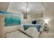 Cozy bedroom featuring a decorative chandelier, wave art and a comfortable white bed at 5161 S Emporia Way, Greenwood Village, CO 80111
