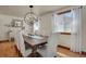 Elegant dining room with a large table, chandelier, and natural light at 5161 S Emporia Way, Greenwood Village, CO 80111