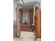Inviting home entrance with red doors, wooden fence, and beautifully landscaped walkway at 5161 S Emporia Way, Greenwood Village, CO 80111