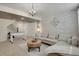 Charming living room with brick accent wall, chandelier, and comfortable sectional sofa at 5161 S Emporia Way, Greenwood Village, CO 80111