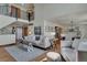 Open-concept living area with hardwood floors, staircase, and access to dining at 5161 S Emporia Way, Greenwood Village, CO 80111