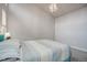 Cozy bedroom with plush carpeting and an eye-catching modern light fixture at 10630 E 26Th Ave, Aurora, CO 80010