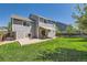 Backyard with lush lawn and patio featuring an awning and outdoor seating at 11034 W Aqueduct Ln, Littleton, CO 80127