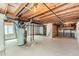 Unfinished basement showing exposed ceiling, concrete floor, and utilities at 11034 W Aqueduct Ln, Littleton, CO 80127