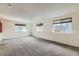 Large basement area with multiple windows and neutral carpet, ready for your personalization at 11034 W Aqueduct Ln, Littleton, CO 80127