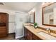 Bathroom features granite countertops, dual sinks, custom cabinets and glass shower at 11034 W Aqueduct Ln, Littleton, CO 80127