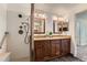 Bathroom features double sink vanity, wood look floors, granite countertops and shower at 11034 W Aqueduct Ln, Littleton, CO 80127