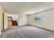 Bedroom with neutral carpet, two doors and a window letting in natural light at 11034 W Aqueduct Ln, Littleton, CO 80127