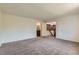 Spacious bedroom with neutral carpet has two doors, and ensuite bathroom at 11034 W Aqueduct Ln, Littleton, CO 80127