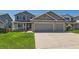 Beautiful two-story gray home featuring a spacious three-car garage and well-kept lawn at 11034 W Aqueduct Ln, Littleton, CO 80127