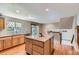 Bright kitchen with a granite island, light wood cabinets, and hardwood floors at 11034 W Aqueduct Ln, Littleton, CO 80127