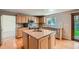 Well-lit kitchen featuring an island, granite countertops, and stainless steel appliances at 11034 W Aqueduct Ln, Littleton, CO 80127