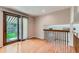 Bright living area features sliding glass doors to the backyard and hardwood flooring at 11034 W Aqueduct Ln, Littleton, CO 80127