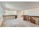 Loft area with wooden railings, access to bedrooms and bathroom, and neutral carpet at 11034 W Aqueduct Ln, Littleton, CO 80127