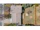 An aerial view of the home showcasing the roof, lot, and yard surrounded by mature trees and a wood fence at 16543 E Kansas Pl, Aurora, CO 80017