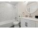 Bathroom featuring updated vanity, modern fixtures, and elegant marbled tiled shower/tub at 16543 E Kansas Pl, Aurora, CO 80017