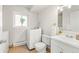 Bathroom including a washer, toilet, sink with storage, and large window at 16543 E Kansas Pl, Aurora, CO 80017