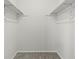 A walk-in closet featuring neutral carpet and shelving, offering ample storage space at 16543 E Kansas Pl, Aurora, CO 80017