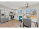 Eat-in kitchen with white cabinetry, stainless steel appliances, and access to the backyard through sliding glass doors at 16543 E Kansas Pl, Aurora, CO 80017