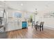 Bright and modern kitchen with white cabinets, sleek appliances, and a dining area by sliding glass doors at 16543 E Kansas Pl, Aurora, CO 80017