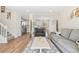 Inviting living room featuring hardwood floors, neutral paint, comfortable seating, and easy access to kitchen at 16543 E Kansas Pl, Aurora, CO 80017
