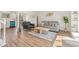Bright living room with hardwood floors, a comfortable gray sofa, and view of a modern kitchen at 16543 E Kansas Pl, Aurora, CO 80017