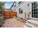 Red brick backyard with wooden fence, small stairs, and gray siding on townhome at 1953 E 102Nd Cir, Thornton, CO 80229