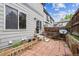 Enclosed backyard with red brick pavers, wood fence, and stairs leading to a sliding glass door at 1953 E 102Nd Cir, Thornton, CO 80229