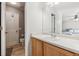 Bathroom featuring a wood vanity, sink, toilet, and a large vanity mirror at 1953 E 102Nd Cir, Thornton, CO 80229