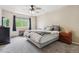 Neutral bedroom featuring a large window, ceiling fan, and two bedside tables at 1953 E 102Nd Cir, Thornton, CO 80229