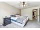 Spacious bedroom with plush carpet, a ceiling fan, and view to an adjoining Bedroom at 1953 E 102Nd Cir, Thornton, CO 80229