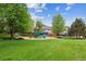Lush green park featuring a playground with mature trees and well-maintained lawns at 1953 E 102Nd Cir, Thornton, CO 80229
