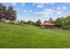 Expansive grassy field in community park featuring a covered pavilion and mature trees in the background at 1953 E 102Nd Cir, Thornton, CO 80229
