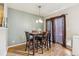 Inviting dining area features wood floors, neutral wall color, and a modern chandelier at 1953 E 102Nd Cir, Thornton, CO 80229
