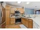 Well-lit kitchen features stainless steel appliances, light-colored cabinets, and ample counter space for meal preparation at 1953 E 102Nd Cir, Thornton, CO 80229