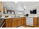 The kitchen features a stainless steel dishwasher and sink, light wood cabinets, and an open view to the living room at 1953 E 102Nd Cir, Thornton, CO 80229