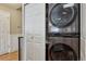 Convenient laundry area featuring a stacked washer and dryer near the entry and closet at 1953 E 102Nd Cir, Thornton, CO 80229
