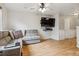 Comfortable living room features wood floors, gray sofa, a mounted television, and a ceiling fan for added convenience at 1953 E 102Nd Cir, Thornton, CO 80229
