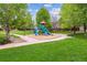 A colorful playground with slides and climbing equipment in a community park with mature trees at 1953 E 102Nd Cir, Thornton, CO 80229