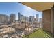 Balcony view of a vibrant cityscape, featuring artificial turf and metal railings to enjoy the urban panorama at 1020 15Th St # 20F, Denver, CO 80202