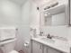 Bright bathroom features white tile, white vanity, and large mirror at 1020 15Th St # 20F, Denver, CO 80202