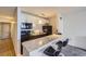 Well-lit kitchen features white cabinets, black appliances, and a counter with barstool seating at 1020 15Th St # 20F, Denver, CO 80202