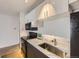 This bright kitchen features white and gray cabinets and black appliances at 1020 15Th St # 20F, Denver, CO 80202